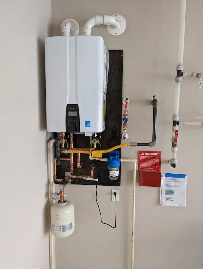 Professional plumber installing copper piping in a Frankford home